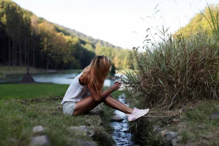 woman-sitting-by-stream-in-nature-scene-2026-09-24-20-18-27-utc